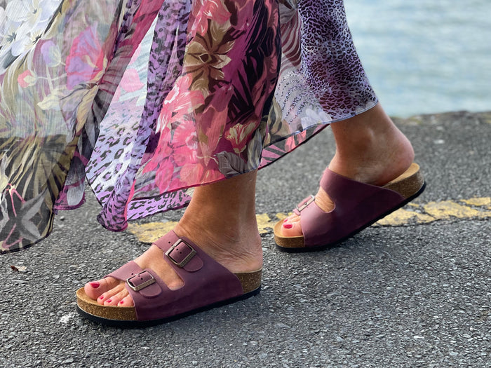 Quality European women's sandals. Made in Spain contoured cork footbed and rubber sole. Comfortable slide style sandal with double buckle detail. Birkenstock style sandal in bordo