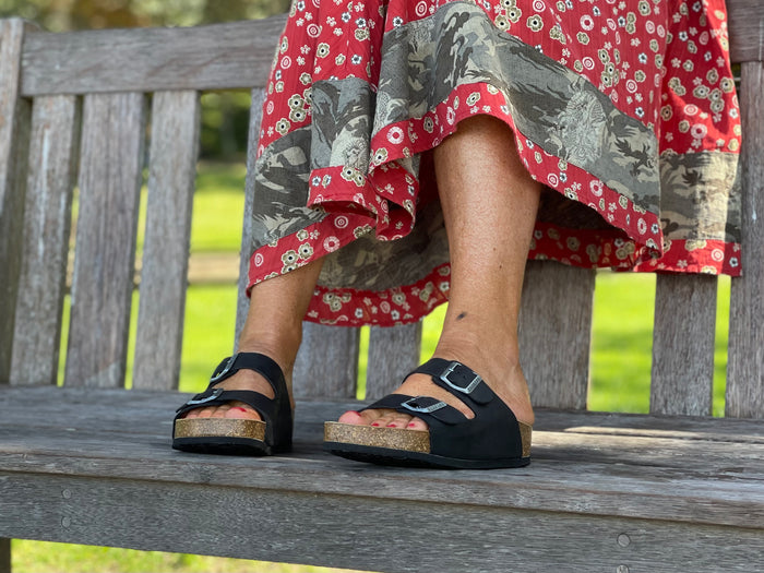 Quality European women's sandals. Made in Spain contoured cork footbed and rubber sole. Comfortable slide style sandal with double buckle detail. Birkenstock style sandal in black.