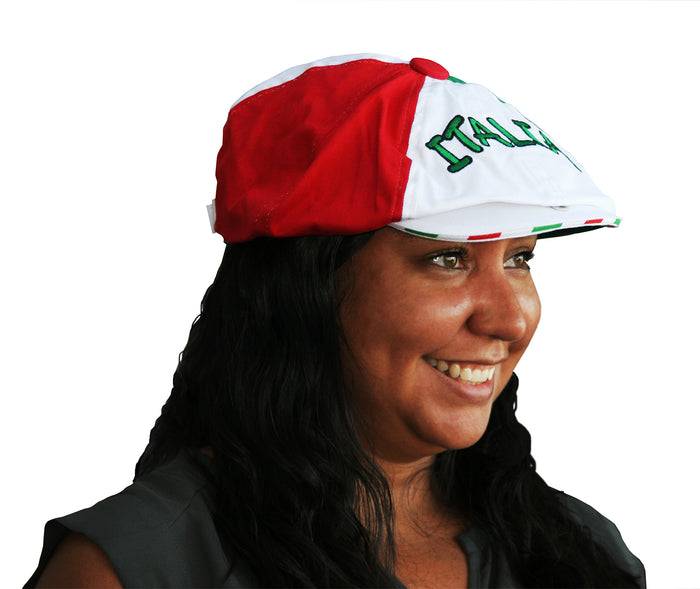 A woman wearing a Gatsby-style cap featuring three distinct panels in red, white, and green, arranged to reflect the Italian flag. The front displays “ITALIA” embroidered in green thread on the white section, with a red button at the crown. A bold and fashionable tribute to Italian heritage and pride.