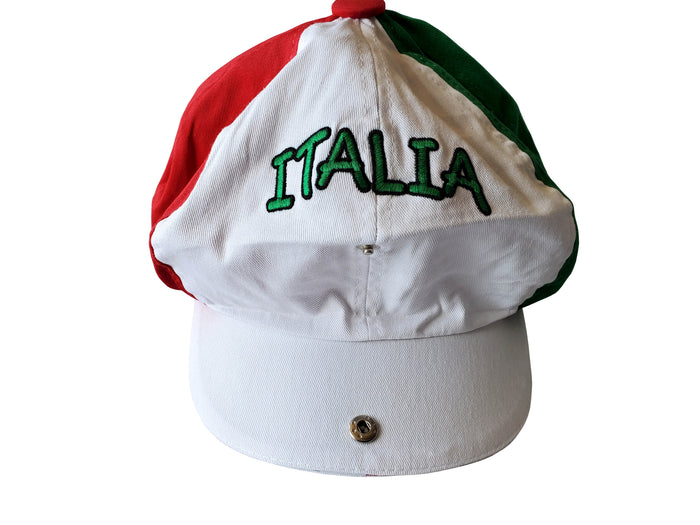 Gatsby-style cap featuring three distinct panels in red, white, and green, arranged to reflect the Italian flag. The front displays “ITALIA” embroidered in green thread on the white section, with a red button at the crown. A bold and fashionable tribute to Italian heritage and pride.